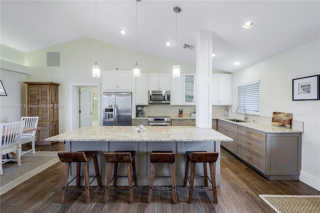 kitchen featuring sink, stainless steel appliances, hanging light fixtures, and dark wood-type flooring