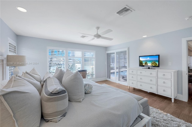 bedroom with access to exterior, hardwood / wood-style floors, and ceiling fan