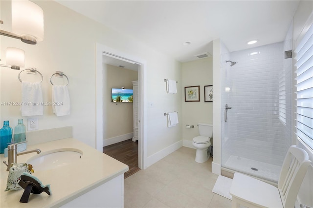 bathroom with vanity, toilet, and a shower with door