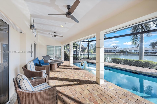 sunroom / solarium featuring ceiling fan, a swimming pool, a water view, and vaulted ceiling