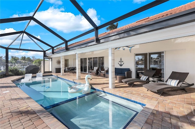 rear view of house featuring glass enclosure, a pool with hot tub, a patio area, and an outdoor hangout area