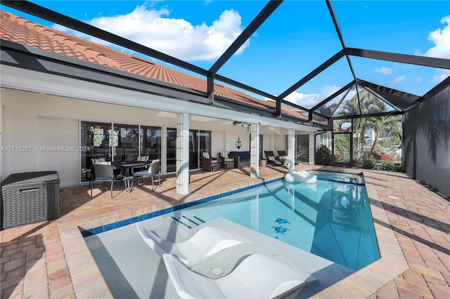 view of swimming pool featuring a lanai, a patio area, ceiling fan, and outdoor lounge area