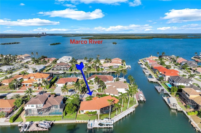 birds eye view of property with a water view