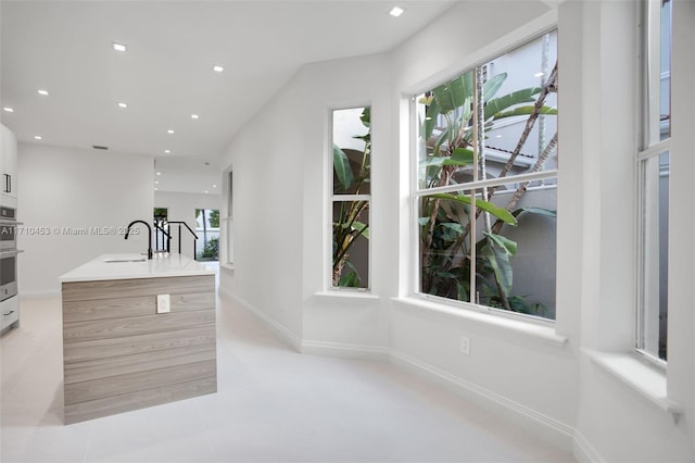 834 E Spinnaker Dr E, Hollywood, FL 33019 - kitchen with sink and light tile patterned flooring