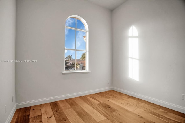 spare room with hardwood / wood-style floors