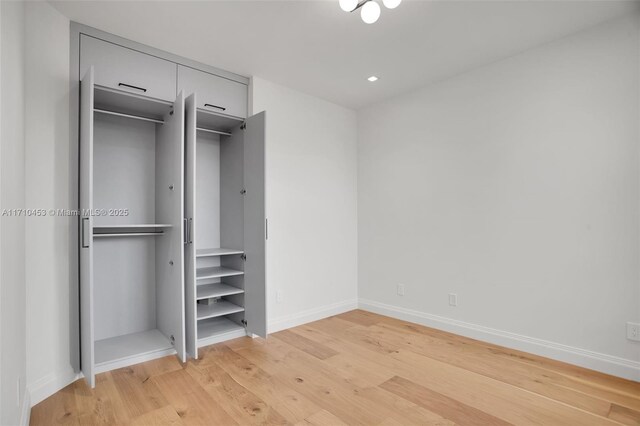 unfurnished bedroom with light wood-type flooring