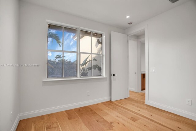 empty room with light hardwood / wood-style floors