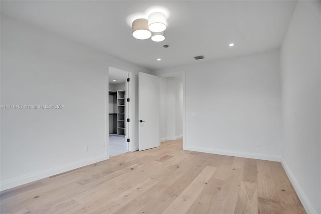 empty room with light hardwood / wood-style flooring