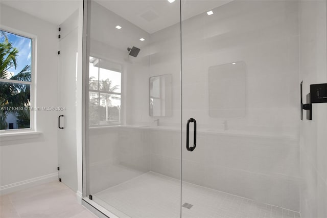 bathroom with tile patterned floors and an enclosed shower