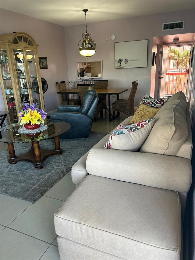 living room with tile patterned flooring and a chandelier