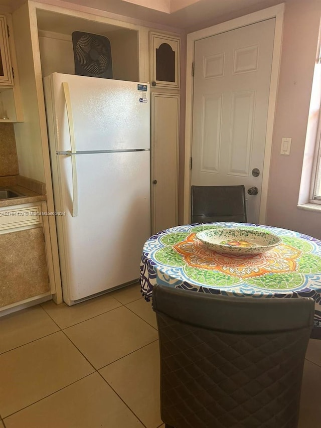 kitchen featuring white refrigerator and light tile patterned floors