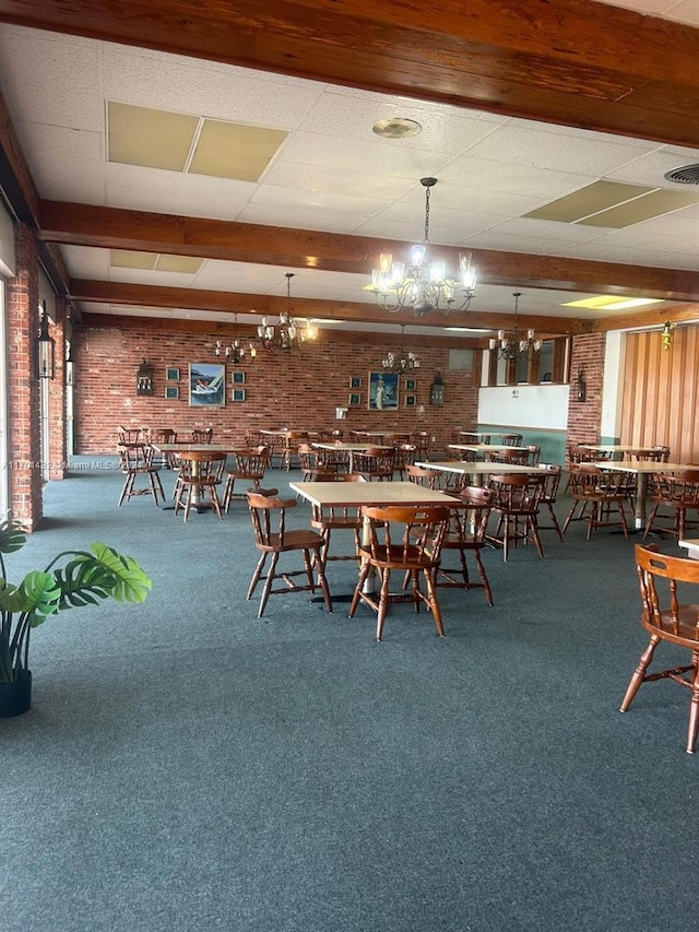 unfurnished dining area with carpet, an inviting chandelier, and brick wall