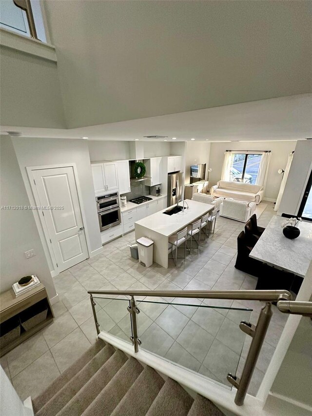 living room with sink and light tile patterned flooring