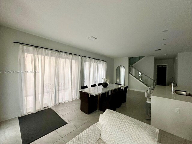 recreation room with sink and light tile patterned floors