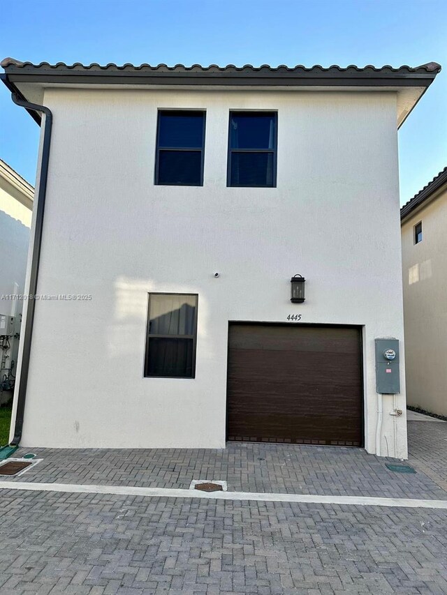 view of side of property with a garage