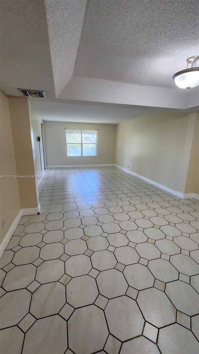 spare room with a textured ceiling