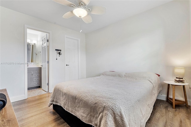 bedroom with wood-type flooring, ensuite bath, and ceiling fan