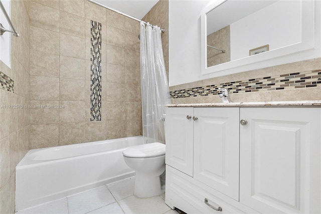 full bathroom featuring shower / tub combo, tile patterned flooring, toilet, vanity, and tile walls