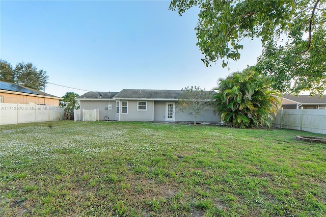 back of property featuring a yard