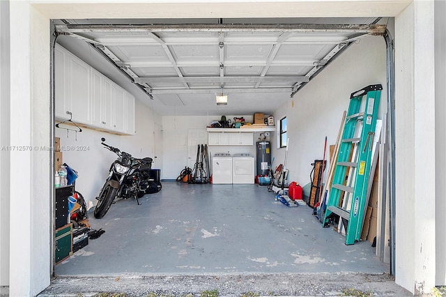 garage with washer and dryer, electric water heater, and a garage door opener