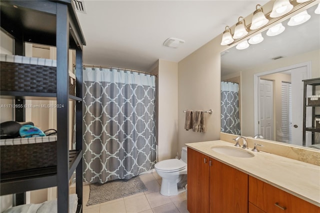 bathroom featuring tile patterned floors, vanity, and toilet