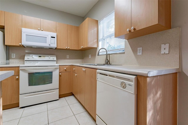 kitchen with sink, light brown cabinets, backsplash, white appliances, and light tile patterned floors