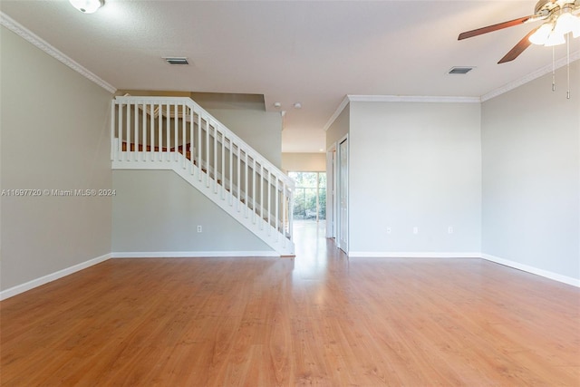 interior space featuring hardwood / wood-style flooring, ceiling fan, and crown molding