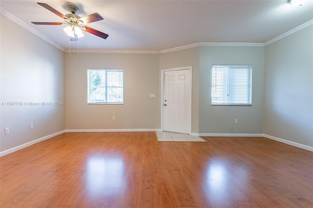 unfurnished room with ceiling fan, light hardwood / wood-style floors, and crown molding