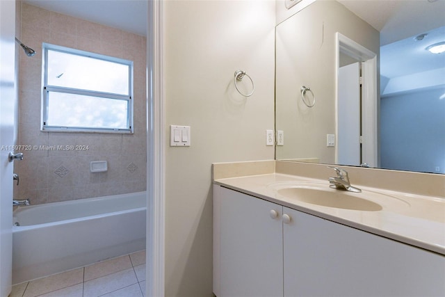 bathroom with tile patterned flooring, vanity, and tiled shower / bath combo