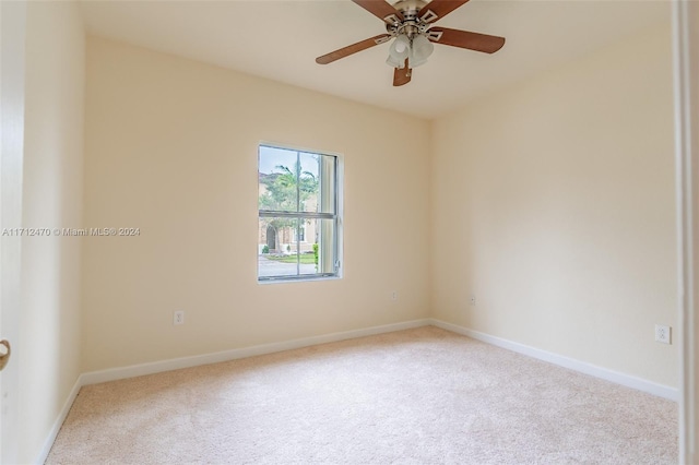 spare room featuring ceiling fan and light carpet