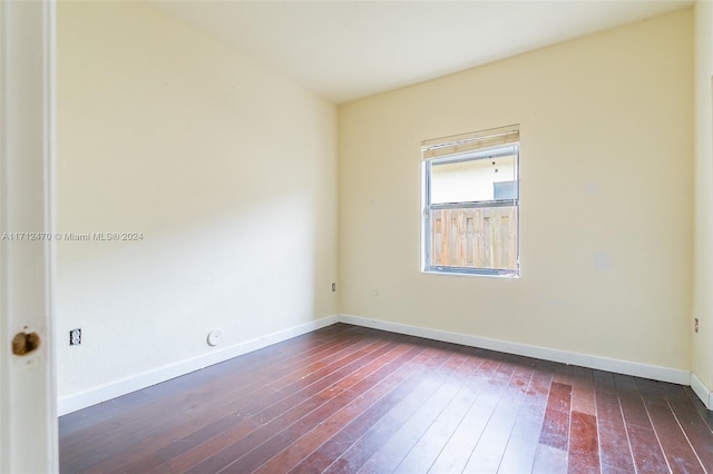 spare room with dark hardwood / wood-style floors