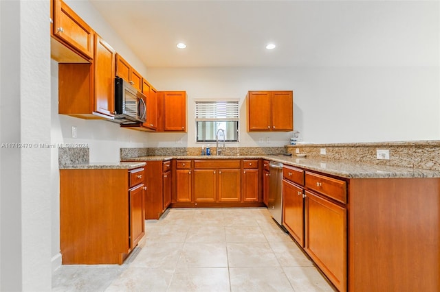 kitchen with sink, light stone countertops, stainless steel appliances, and light tile patterned floors