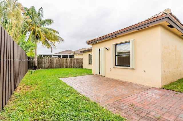 back of house featuring a yard and a patio