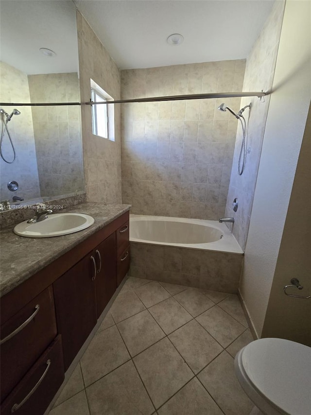 full bathroom featuring vanity, tiled shower / bath combo, toilet, and tile patterned flooring