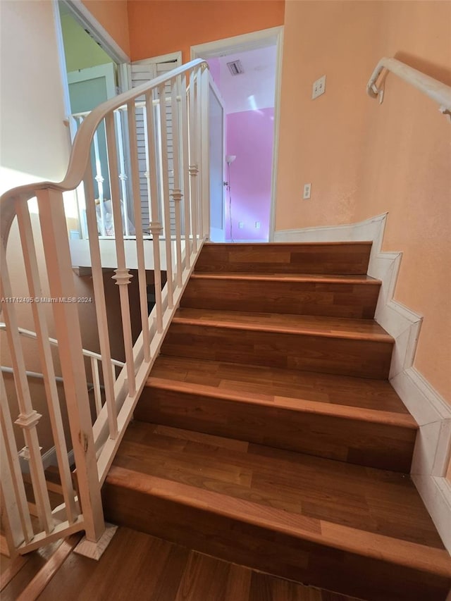 staircase with wood-type flooring