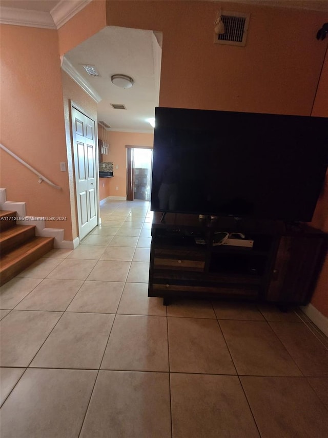 hallway with ornamental molding and light tile patterned flooring