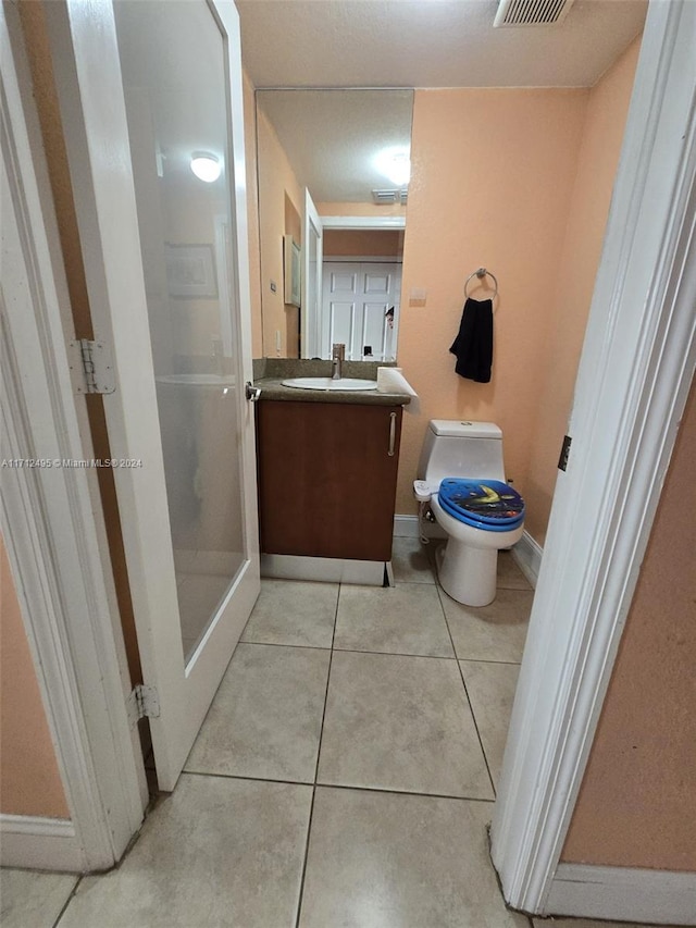 bathroom with tile patterned floors, vanity, and toilet