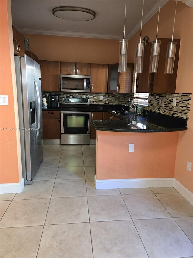 kitchen with backsplash, kitchen peninsula, hanging light fixtures, and appliances with stainless steel finishes