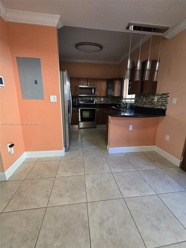 kitchen featuring backsplash, electric panel, appliances with stainless steel finishes, decorative light fixtures, and kitchen peninsula