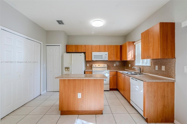 kitchen with a center island, white appliances, backsplash, sink, and light tile patterned floors