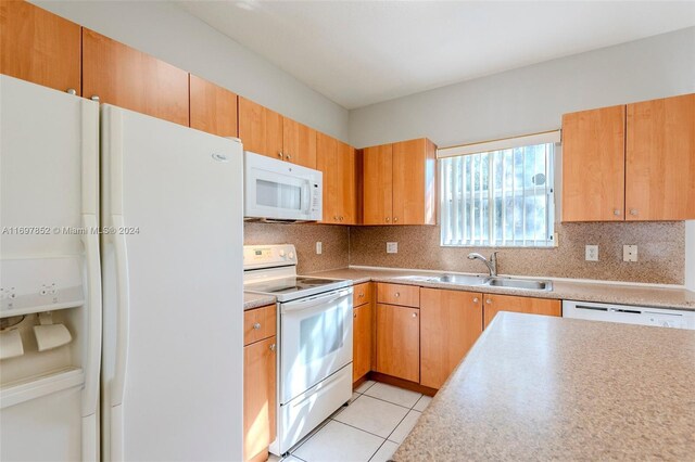 kitchen featuring white appliances, sink, light tile patterned floors, and tasteful backsplash