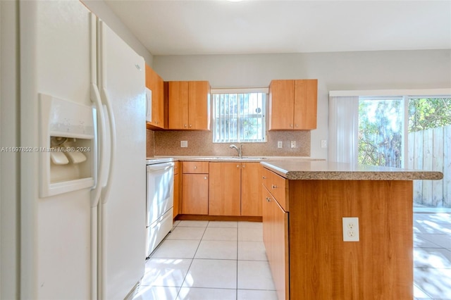 kitchen with white refrigerator with ice dispenser, stove, tasteful backsplash, and plenty of natural light