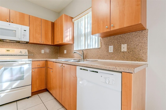 kitchen with backsplash, sink, light tile patterned floors, and white appliances