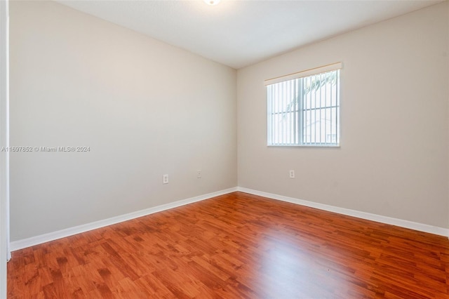 spare room with wood-type flooring