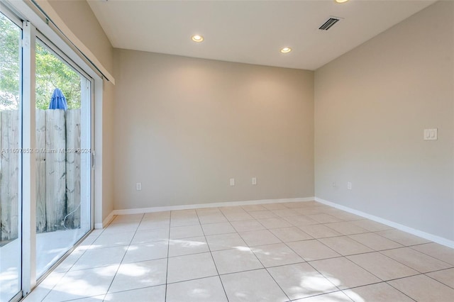spare room featuring light tile patterned flooring