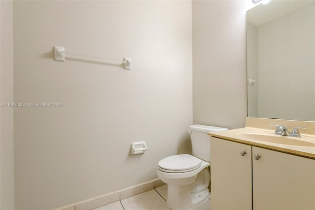 bathroom featuring tile patterned flooring, vanity, and toilet