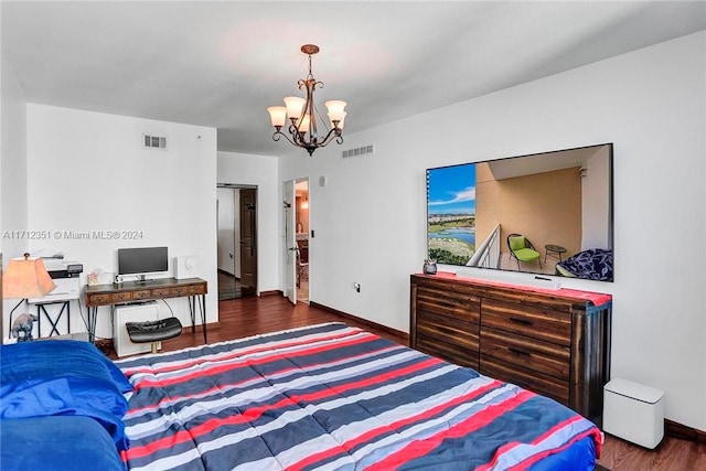 bedroom featuring a chandelier and dark hardwood / wood-style floors