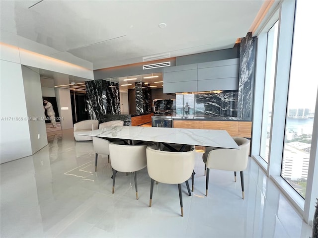 tiled dining room with a water view