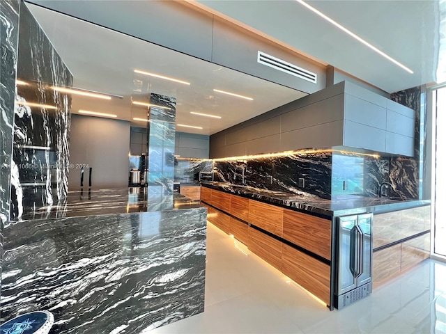 kitchen with dark stone countertops and tile walls