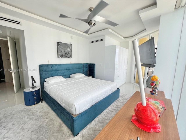 bedroom featuring an AC wall unit and ceiling fan